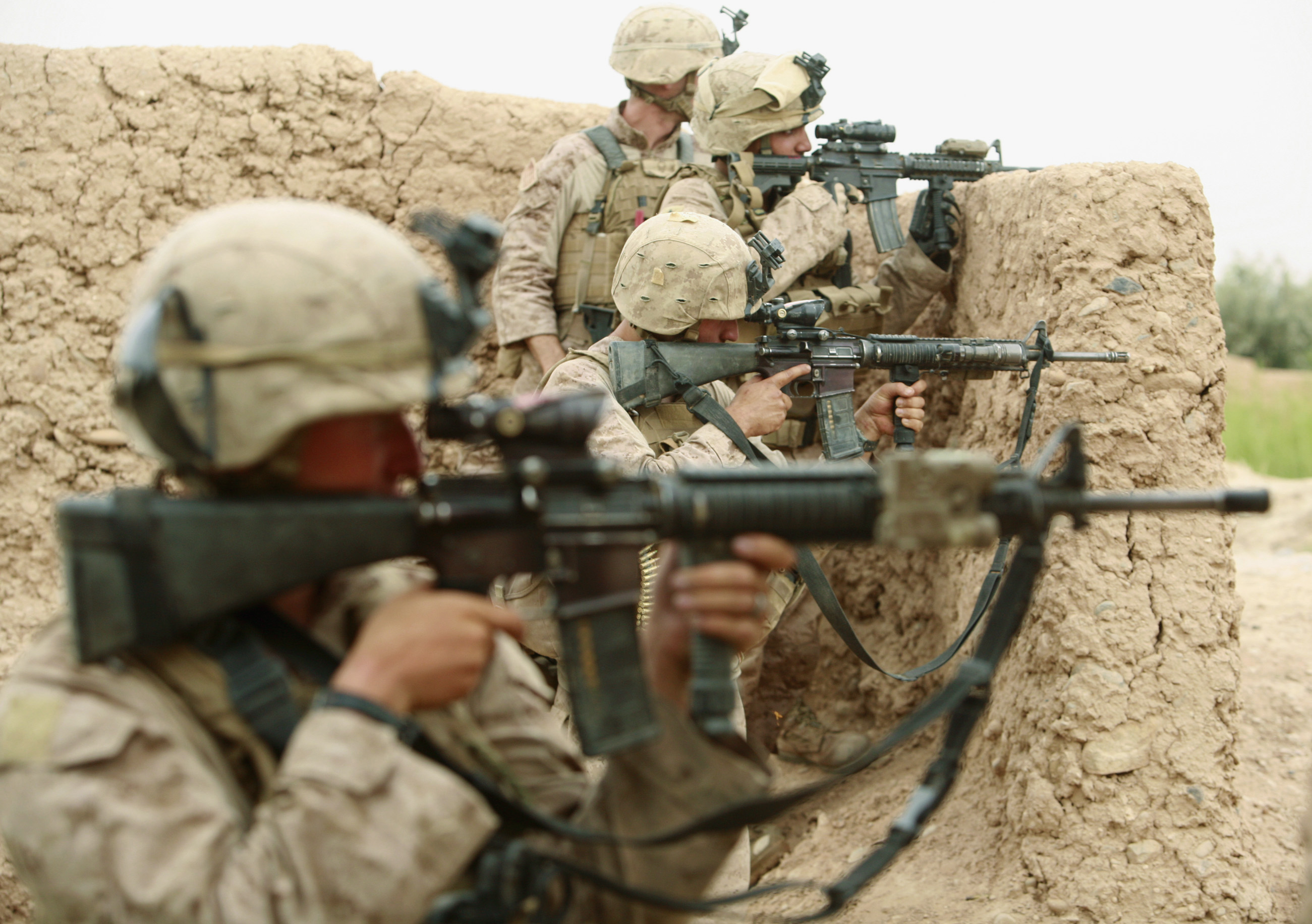 U.S. Marines from Lima Company 3rd Battalion, 6th Marines aim their weapons during a shootout with Taliban fighters in Karez-e-Sayyidi in the outskirts of Marjah district